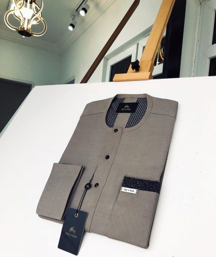 A Carton-colored kaftan with a clear view of black Swarovski button detailing and sokoto