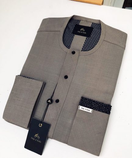 A Carton-colored kaftan with a clear view of black Swarovski button detailing and sokoto