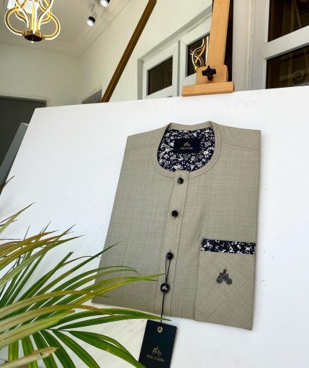 A Dark cream African kaftan with a clear view of Swarovski and buttons with paisley detailing