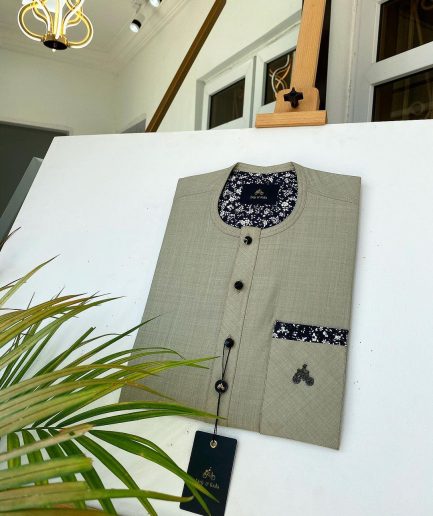 A Dark cream African kaftan with a clear view of Swarovski and buttons with paisley detailing