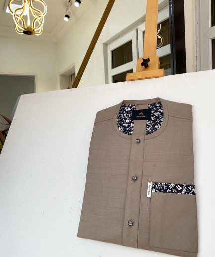 A Carton brown African kaftan with paisley details, Swarovski buttons and sokoto