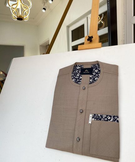 A Carton brown African kaftan with paisley details, Swarovski buttons and sokoto