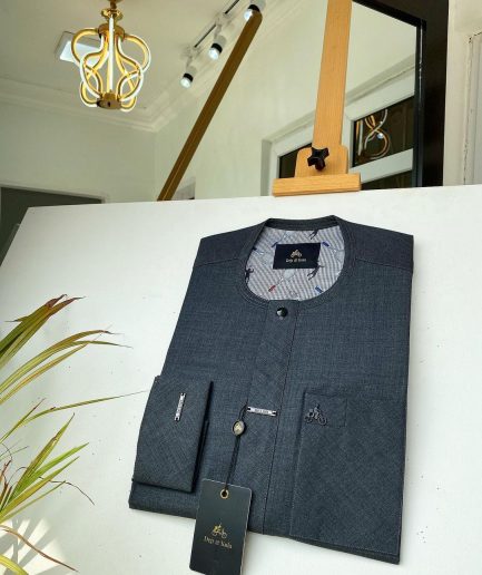 An Irish Grey African kaftan with a black Swarovski button and metal detailing