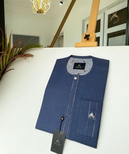 A navy blue kaftan with an interlocking patch pocket design.