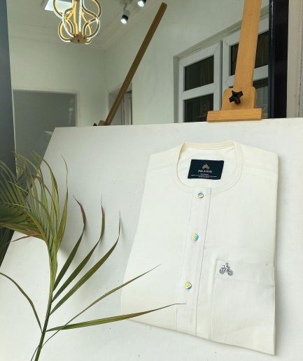 An Ivory white with a matching rainbow-shaded glass button African Kaftan