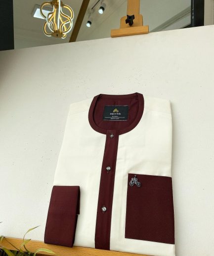 An Ivory white kaftan with a burgundy mix flap, pocket, and cuff design African Kaftan