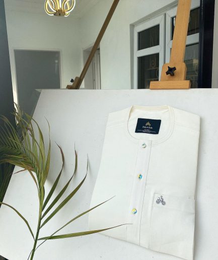 An Ivory white with a matching rainbow-shaded glass button African Kaftan