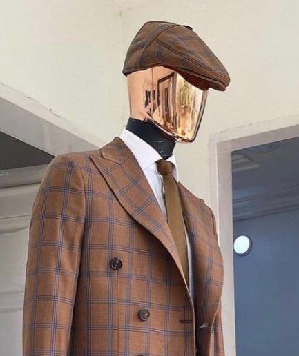 A brown and blue windowpane check papas hat.