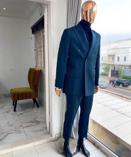 An Army green double-breasted peak lapel suit