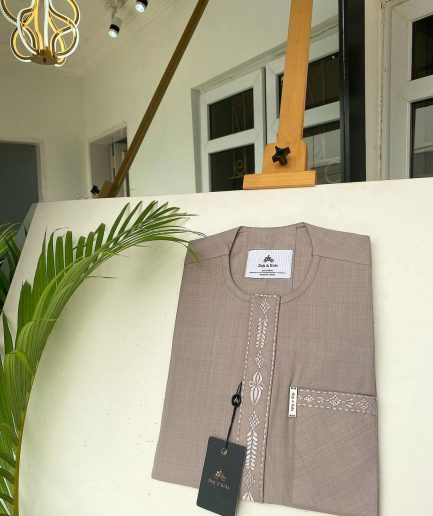 A light lilac senator African kaftan with a dispersed connected embroidery design