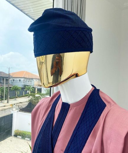 A light beige agbada with a navy blue uncoordinated lines embroidery design, Yoruba embroidery hat, kaftan and sokoto