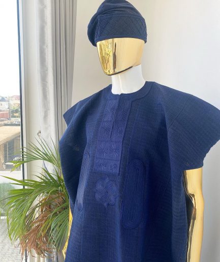 A navy blue aso oke dashiki with a floral and box-shaped embroidery design and hand-embroidered Yoruba hat