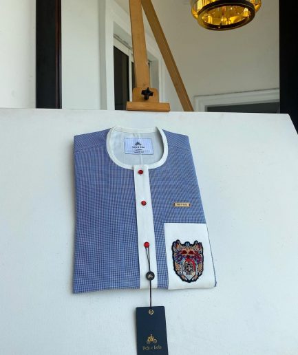 A Windowpane check blue and white mix front flap, hand embroidery patch detailing, and a red Swarovski African Kaftan and Sokoto