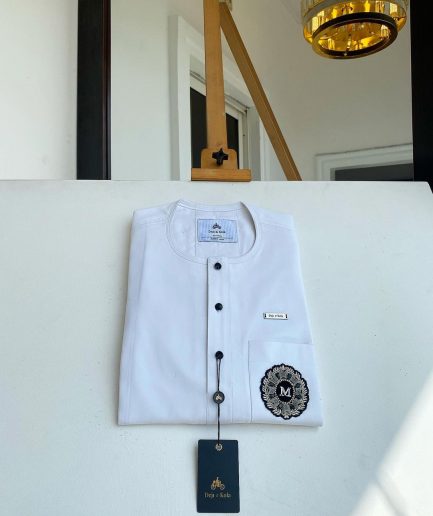 A white mix kaftan, button front flap, hand embroidery patch and black Swarovski detailing African Kaftan and Sokoto