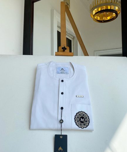 A white mix kaftan, button front flap, hand embroidery patch and black Swarovski detailing African Kaftan and Sokoto