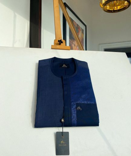 A midnight blue with a paisley flowery left section, complementary front flap, and patch pocket African Kaftan