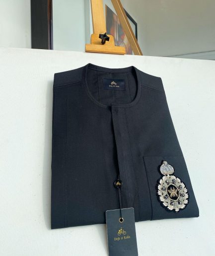 A charcoal black front flap and hand embroidery patch detail traditional African kaftan