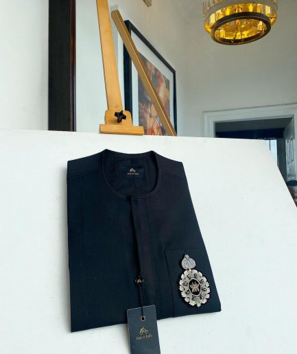 A charcoal black front flap and hand embroidery patch detail traditional African kaftan