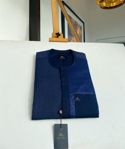 A midnight blue with a paisley flowery left section, complementary front flap, and patch pocket African Kaftan