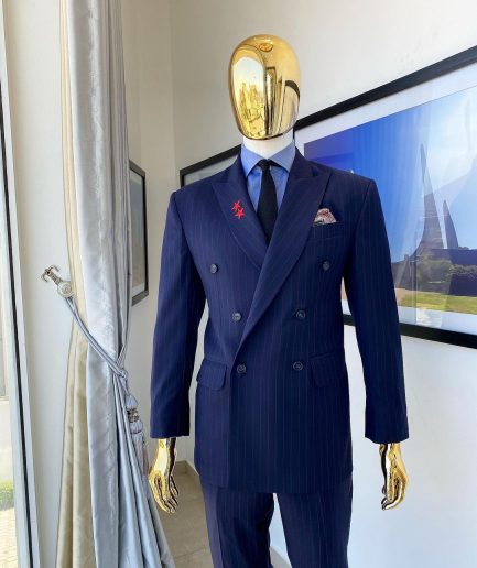 A Navy blue pinstripe double-breasted “Board Room” peak lapel suit