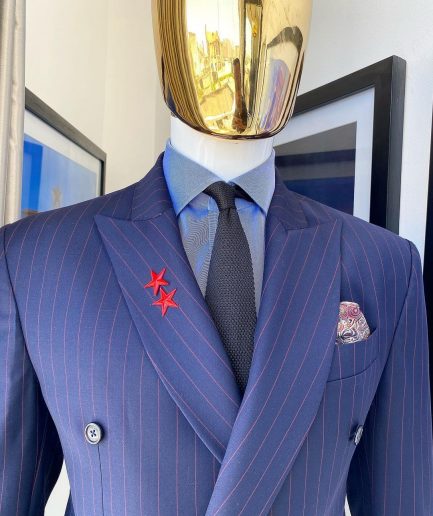 A Navy blue pinstripe double-breasted “Board Room” peak lapel suit