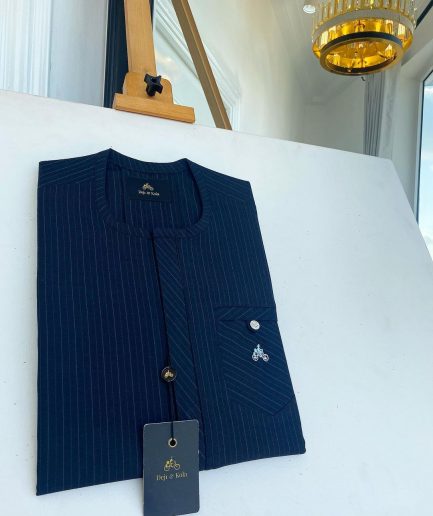 A Navy blue pencil stripe combat pocket with a clear view Swarovski silver button, front flap African kaftan native
