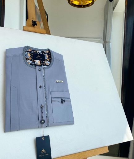 A cadet grey patch pocket and a front flap with a clear view of Swarovski button detail traditional Senator Kaftan native