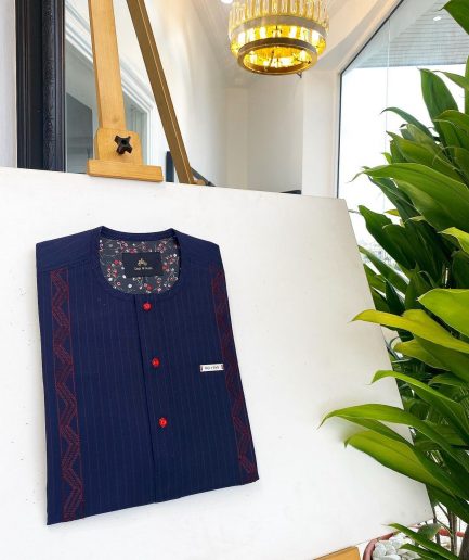 A midnight blue, red pencil stripe, clear view lipstick, red buttons, and horizontal embroidery details African traditional senator Kaftan native