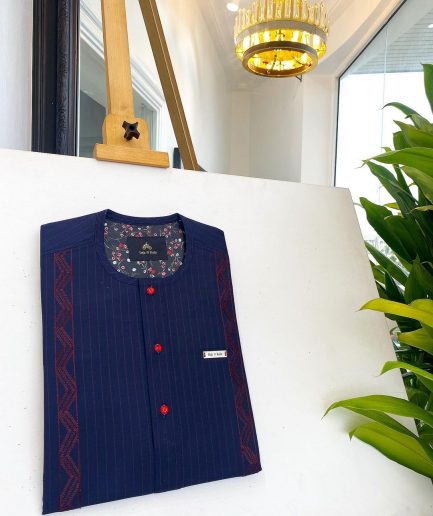 A midnight blue, red pencil stripe, clear view lipstick, red buttons, and horizontal embroidery details African traditional senator Kaftan native