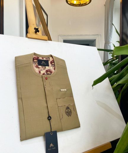 A tortilla brown, lipstick red clear view Swarovski buttons detailing African traditional senator kaftan native.