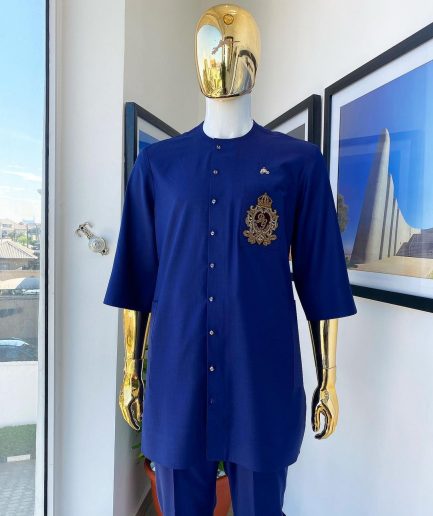 A navy blue “shirtan”, clear view jet black Swarovski button detailing, and hand-woven metal wire embroidery patch African traditional senator kaftan native