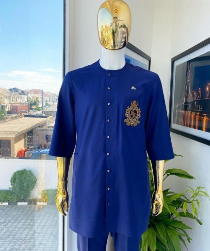 A navy blue “shirtan”, clear view jet black Swarovski button detailing, and hand-woven metal wire embroidery patch African traditional senator kaftan native