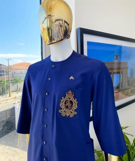 A navy blue “shirtan”, clear view jet black Swarovski button detailing, and hand-woven metal wire embroidery patch African traditional senator kaftan native
