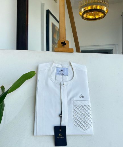 An Ivory White, clear view silver Swarovski buttons, ruffle pocket details, African traditional senator kaftan native.
