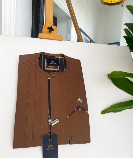 A caramel brown strap and roof pocket, a single button front flap African traditional senator kaftan native.