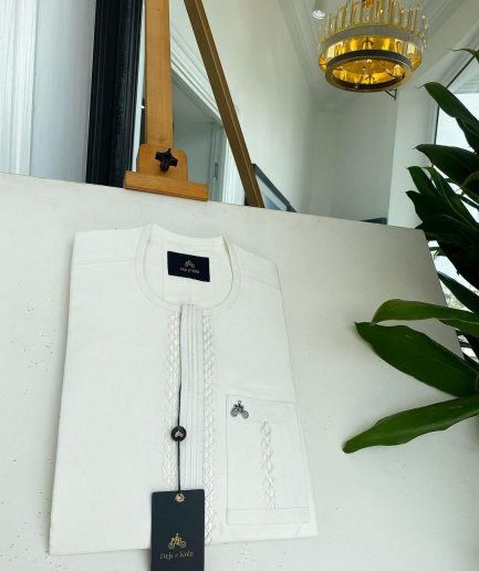 An ivory white, interwoven embroidery front flap and embroidery pocket detail African traditional senator kaftan native