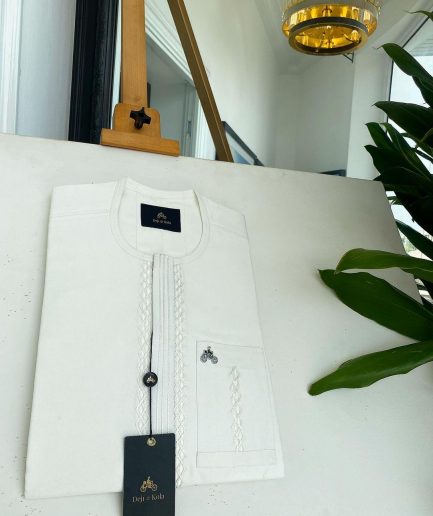 An ivory white, interwoven embroidery front flap and embroidery pocket detail African traditional senator kaftan native