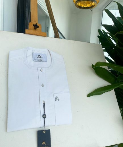A white, clear view, transparent Swarovski buttons, front flap, and patch pocket detail African traditional senator Kaftan native.