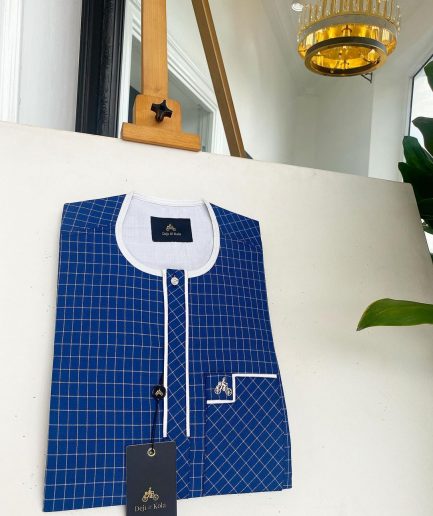 An ivory white and blue check, clear view transparent Swarovski buttons, front flap details African traditional senator kaftan native.