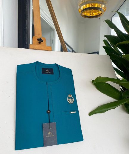 A teal green, tiny flap, and gold bee crown detail an African traditional senator kaftan native.