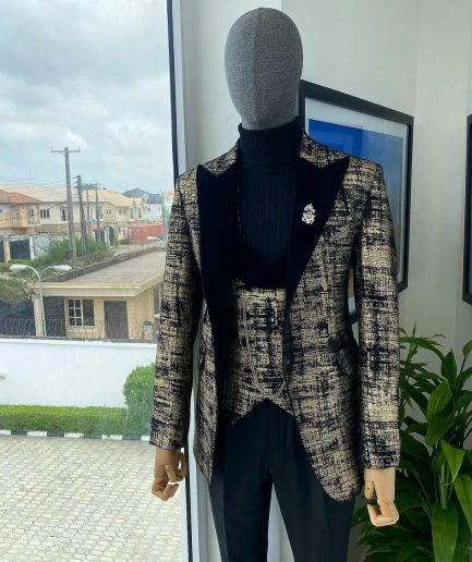 A “Mandarin” Dispersed Black And Gold Peak Lapel Suit.