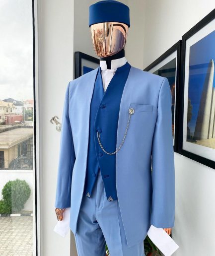 A reloaded ceremonial “Ayeye” Ijade 20/21 - Look 5- “Tokunbo” look. Powder blue half section back slant cut jacket