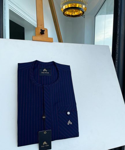 A pencil stripe midnight blue and red front flap with an inverse combat pocket Swarovski button details African traditional senator Kaftan native