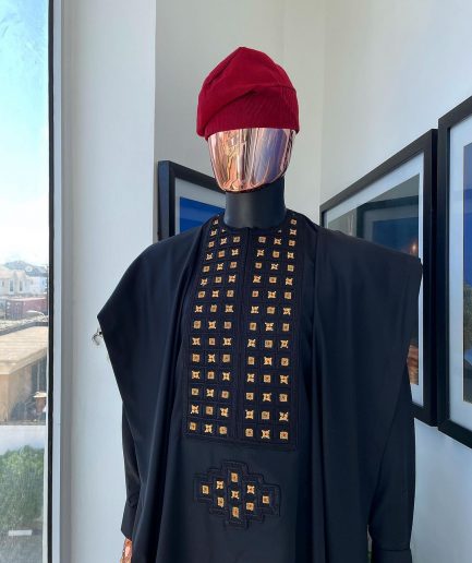 A charcoal black, connected square embroidery design with matching gold and red Swarovski stone details agbada