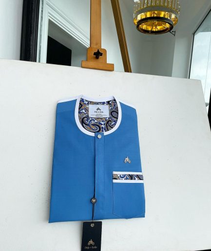 A cerulean blue, vertical flap with horizontal paisley patch pocket detailing and a Swarovski button African traditional senator kaftan native
