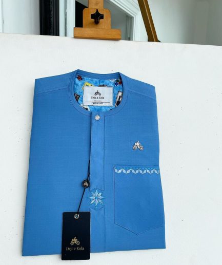 A cerulean blue, vertical Flap with Swarovski button on flap, related embroidery detailing African traditional senator kaftan native.