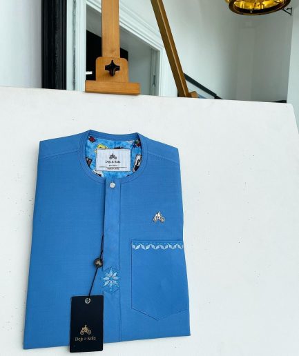 A cerulean blue, vertical Flap with Swarovski button on flap, related embroidery detailing African traditional senator kaftan native.