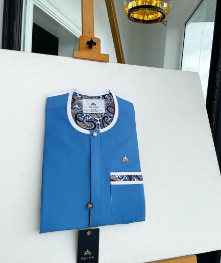 A cerulean blue, vertical flap with horizontal paisley patch pocket detailing and a Swarovski button African traditional senator kaftan native