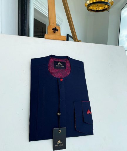 A Midnight blue with paisley detailing, front flap, and a layered patch pocket with a matching Swarovski button African traditional kaftan native