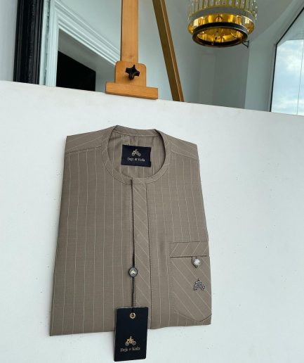 A pencil-striped tortilla brown front flap with an inverse combat pocket Swarovski button details African traditional senator Kaftan native